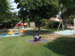 a park with a playground with a swing at VVF Sigean Port-la-Nouvelle Corbières in Sigean