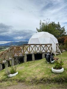 a domed building with a tent on a field at DOMO Roca Glamping Suesca in Suesca +15 photos