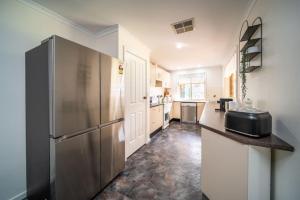 a kitchen with a stainless steel refrigerator at Escape to Adelaide Hills - Spacious Country Stay in Nairne