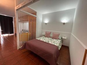 a small bed with two pillows in a room at Practical and cozy apartment in southern Arona in Arona +48 photos