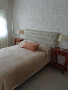 a bedroom with a large bed with two night tables at MRU Colón aparts in Colón