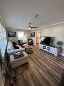 a living room with a couch and a tv at Central Charleston Area Hideaway in Charleston