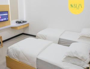 Säng eller sängar i ett rum på Hotel Beza