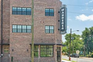 a brick building with a sign on the side of it at Hip New Condo near Broadway and Trendy East Nash with 5 Beds in Nashville