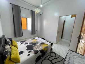 1 dormitorio con cama y espejo. en Villa avec piscine ( régions de Marrakech), 