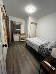 a bedroom with a bed and a television in it at Bethel Woods Cabin in Mongaup Valley