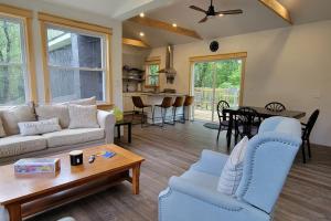 a living room with a couch and a table at Bethel Woods Cabin in Mongaup Valley