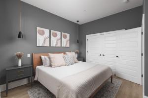 a bedroom with a white bed and a large closet at Modern East Nashville Condo 3 Miles to Downtown in Nashville
