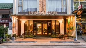um hotel com uma placa que lê o hotel ribeirinho em Riverside Hotel em Vientiane