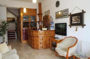 a living room with a tv and a couch and a chair at Goren Hotel in Çeşme