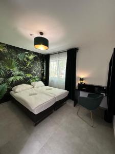 a bedroom with a bed and a plant wall at EasyLiving Darmstadt in Darmstadt