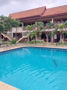 a large blue swimming pool in front of a building at Sofia Garden Resort in Ko Chang