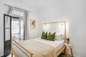 a bedroom with a bed with green pillows at Surry Hills l 2 Bedroom Terrace Home in Sydney