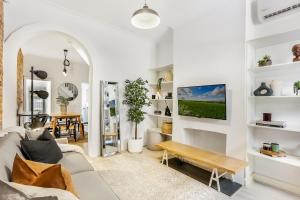 a living room with a couch and a table at Surry Hills l 2 Bedroom Terrace Home in Sydney