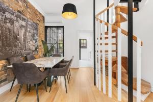 a dining room with a table and chairs at Ultimo l Renovated 2 Bedroom House With Rooftop Balcony in Sydney