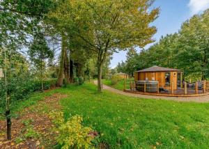 a gazebo in the middle of a field with trees at Mallory Meadows in Kirkby Mallory