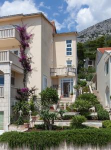 um edifício com flores ao lado em Apartmens Villa Antonio 88 em Brela