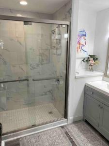a glass shower in a bathroom with a sink at Big Pool, stunning Lakeview, Sunrise, Disney #1907 in Orlando