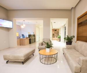 a living room with a couch and a table at Aphrodite Beach in Kissamos