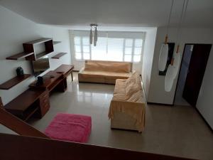 a living room with a couch and a table at Casa independiente, ciudad jardín in Cali