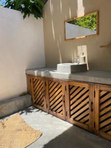 a bathroom with a sink and a mirror at Gypsea Cabana in Arugam Bay