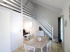 a dining room with a table and a staircase at Gîte Arnac, 2 pièces, 4 personnes - FR-1-742-298 