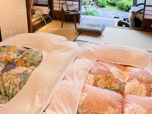Postel nebo postele na pokoji v ubytování Kyounoyado HANA Nishijin - Kimono no Yado