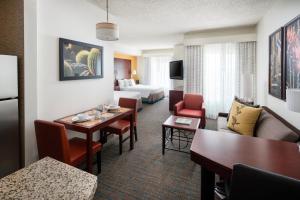 a hotel room with a table and a living room at Residence Inn Phoenix Desert View at Mayo Clinic in Phoenix