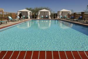 einen großen Pool mit Stühlen und Pavillons in der Unterkunft Residence Inn Phoenix Desert View at Mayo Clinic in Phoenix