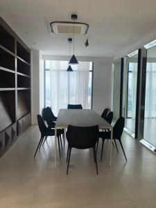 a dining room with a table and chairs at Aveline Suites Aesthetic Skydeck View ACQUA Private Residences near Rockwell Makati in Manila
