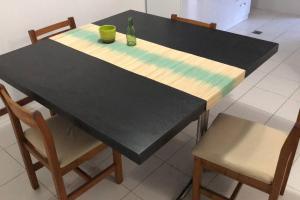 a black table with two chairs and a bottle on it at NEW!Departamento x 4 pesonas. in Malargüe