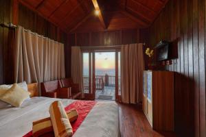 a bedroom with a bed and a view of the ocean at Manta Cottage Seaview Plus in Nusa Penida