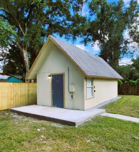 um pequeno barracão com uma porta azul num quintal em Cozy Cottage em Tampa