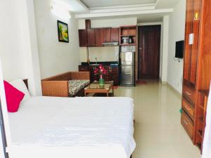 a small room with a bed and a kitchen at Q.MIN apartment in Nha Trang