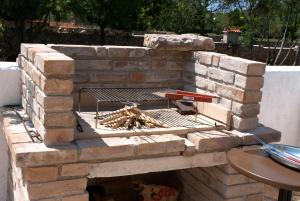 a brick fireplace with a grill on top of it at House Soni - 800 m from the sea in Rovinj