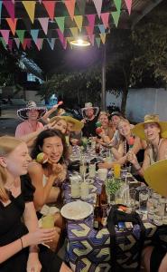 a group of people sitting around a long table at MOHO in Moalboal