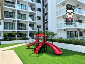 a playground in front of a apartment building at Staycation Homestay 26 P Residence near bt kawa in Kuching