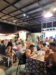 a group of people sitting at tables playing chess at MOHO in Moalboal