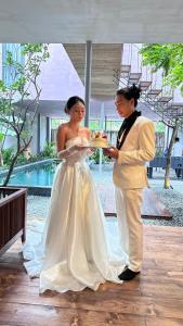 a bride and groom standing next to each other at AnNam Village in Vung Tau