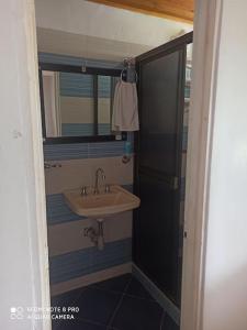 a bathroom with a sink and a mirror at Finca Villa Claudia campestre 