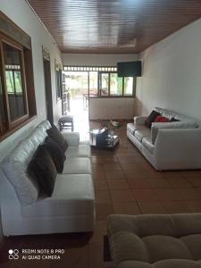 a living room with two white couches and a tv at Finca Villa Claudia campestre 