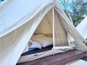 a canvas tent with a bed in it at Touching Camping in Hou-lung-tzu