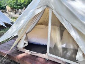 a bed in a tent on a wooden deck at Touching Camping in Hou-lung-tzu