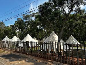 a fence with white structures in a park at Touching Camping in Hou-lung-tzu