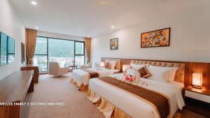 a hotel room with two beds and a large window at YEN BIEN LUXURY HOTEL in Ha Giang