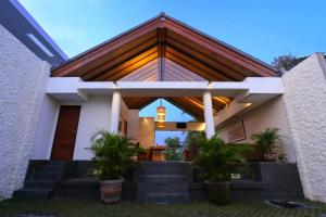 a house with some plants in front of it at Affordable villa @Nyanyi, near Tanah Lot Temple in Munggu