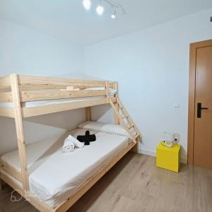 a bunk bed with a teddy bear sitting on the bottom bunk at Apartamento con terraza y acceso directo a piscina in Denia