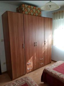 a large wooden cabinet in a bedroom with a bed at Mi casa es la tuya in Bueu