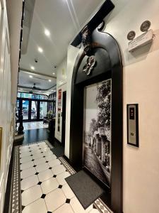 a hallway with a black and white tile floor at Camellia Residence Hanoi in Hanoi