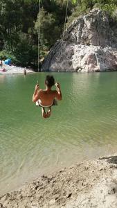 a man on a swing in the water at a beach at A s'antiga in Seùlo